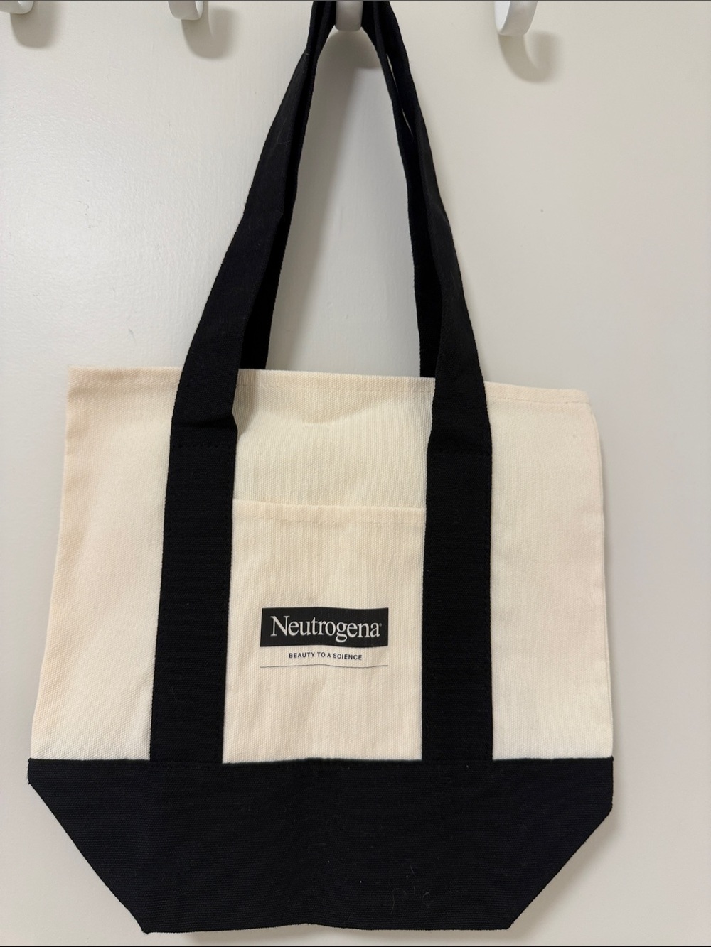 Neutrogena Cream and Black Canvas Tote with Front Logo Pocket